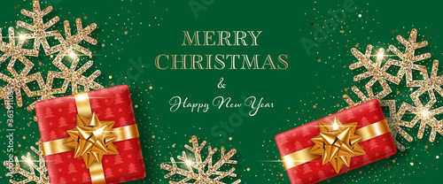 Christmas background with shiny snowflakes made of golden confetti and gift boxes. Design element for greeting card, party invitation or banner