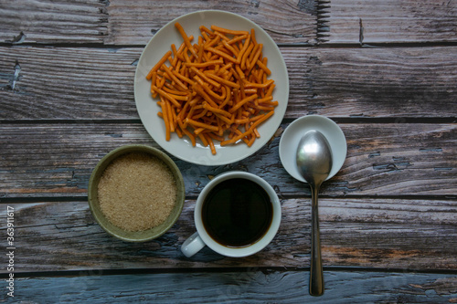 A cup of coffee And snacks On the old blue wood background
