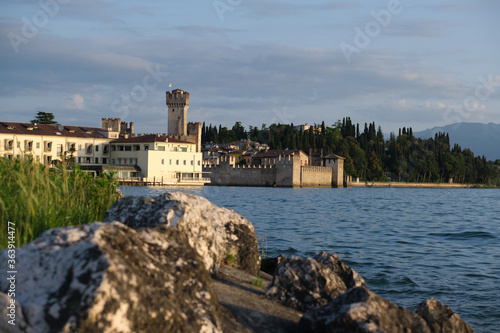 Sirmione Castle, Lake Garda Italy. Early morning historic city. Stones in the foreground