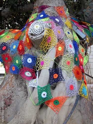 crochet square decoration on tree trunk