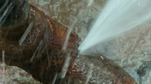 Water flows from a rusty water pipe. Water accident