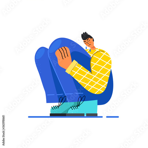 Image of a sad young guy sitting and unhappily hugging his knees and crying. The man is depressed. Vector stock illustration. Flat design. Isolated on a white background.