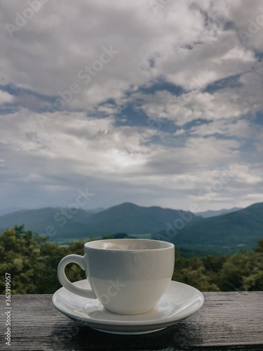 cup of tea on a plate on a background of mountains and nature
