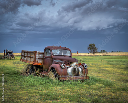 Old  abandoned vehicles on the Great Plains as Severe Weather Approaches