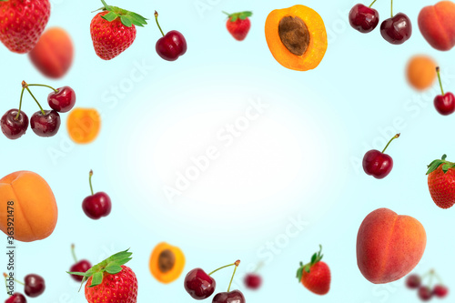 Background with flying ripe summer fruits frame on light blue background with copy space