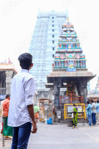 A young man stands with back view on the temple © avs
