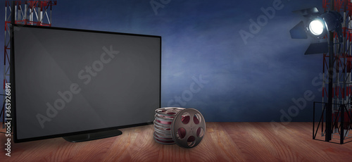 Video on demand advertizing template with an empty TV, film reels and spotlight. A movies concept with copy space to add your own titles photo