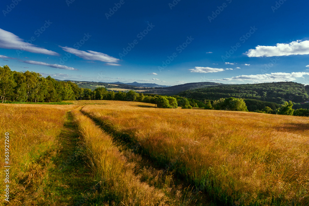 Beautiful panorama sunset view on mountains with field