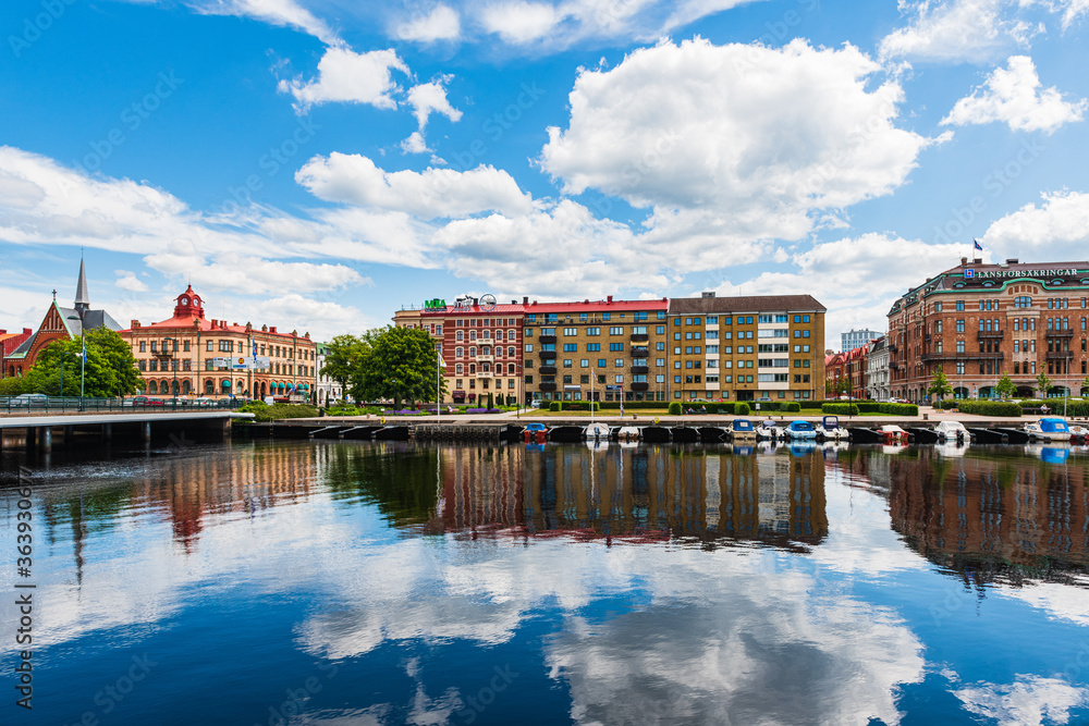 Obraz premium Buildings at Halmstad city in front of still river, Sweden
