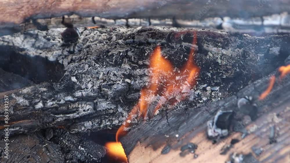 Close up embers flames and smoke middle of a campfire ready for marshmallows slow motion. Close up embers flames and smoke middle of a campfire ready for marshmallows slow motion.