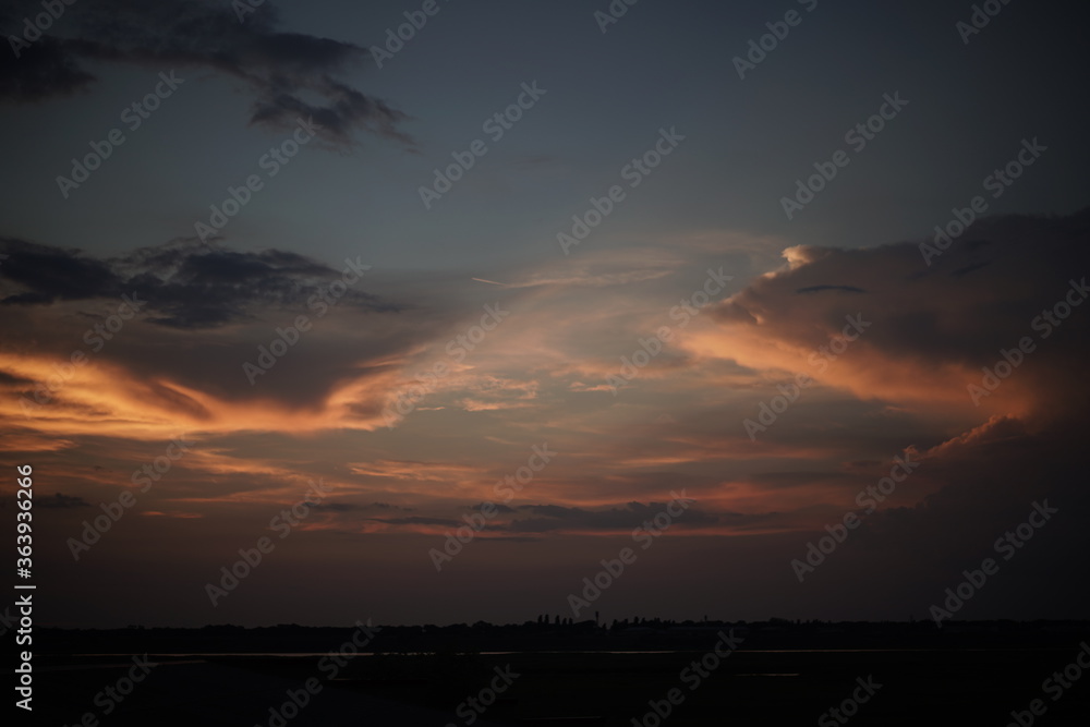 Dark sunset sky in evening. Colorfull sky landscape in the light of sun. Nature beauty concept.