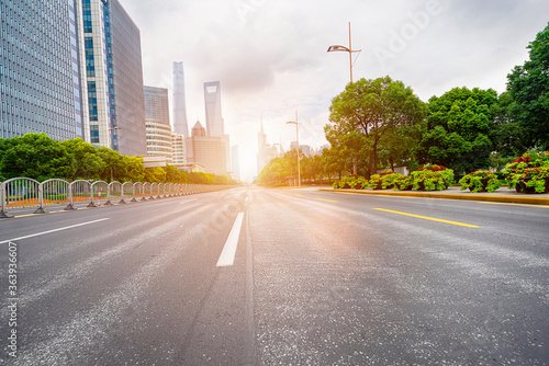 Highways and tall buildings stretch under the blue sky at dusk.