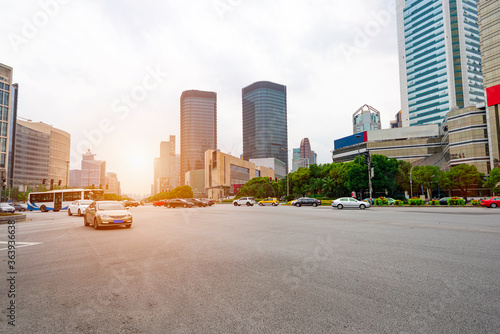 Highways and tall buildings stretch under the blue sky at dusk.