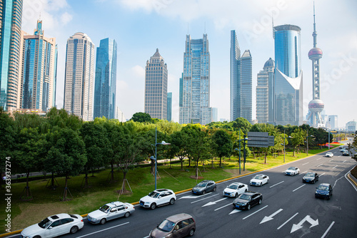 A cluster of tall buildings and cars on the highway in Shanghai