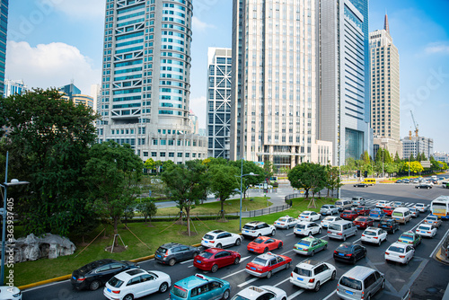 A cluster of tall buildings and cars on the highway in Shanghai
