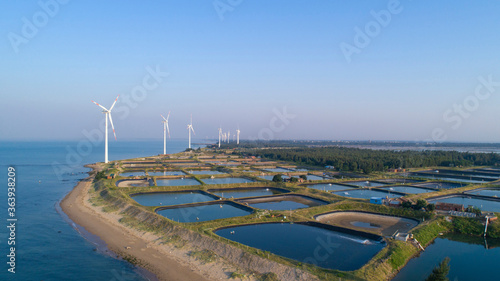 Seaside wind power generation and coastal salt and farming farms. photo