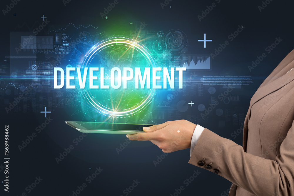 Close-up of a touchscreen with DEVELOPMENT inscription, new technology concept Close-up of a touchscreen with DEVELOPMENT inscription, new technology concept