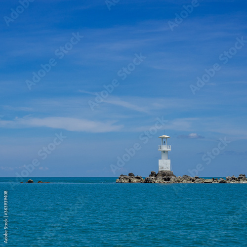 Wallpaper Mural Lighthouse in bright sunny summer day in the sea of Thailand. Rocky coast under the blue sky with cloud and calm water. Torontodigital.ca