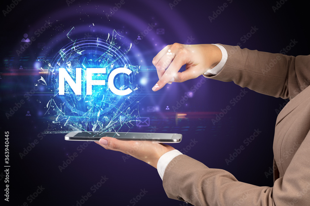 Close-up of a touchscreen with NFC abbreviation, modern technology concept Close-up of a touchscreen with NFC abbreviation, modern technology concept
