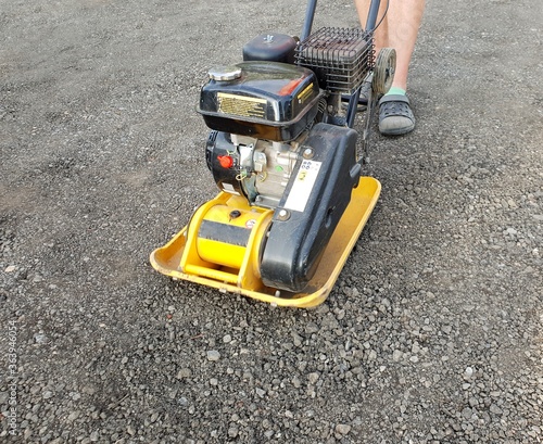 Fotografie Worker using vibrating plate.