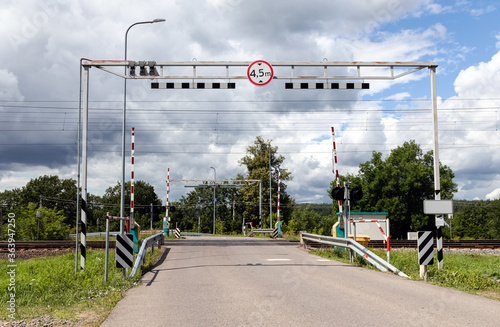 Railroad crossing in the suburbs. Summer. Day.