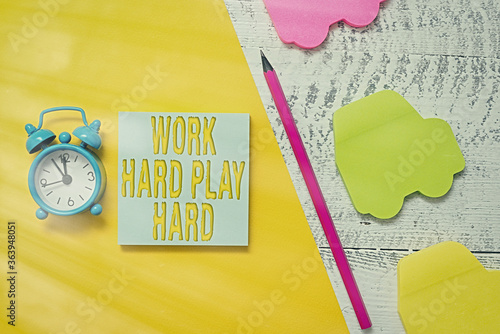 Text sign showing Work Hard Play Hard. Business photo showcasing diligent in any activity Party at weekends Hardworking Notepad car sticky notes pen paper sheet alarm clock wooden background photo