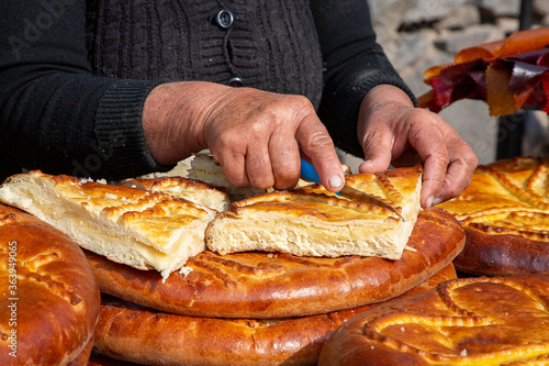 Cutting Armenian bread known as Gata Bread, Armenia photo