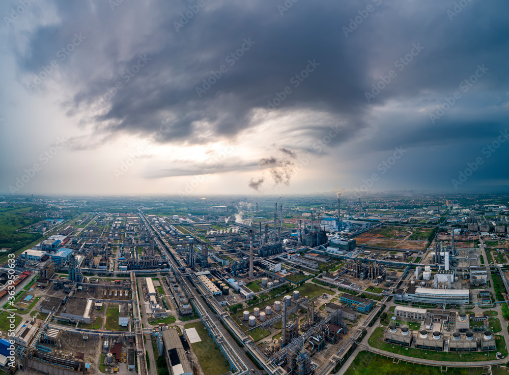 Fototapeta premium Aerial photo of the petrochemical refinery under blue sky and white clouds.
