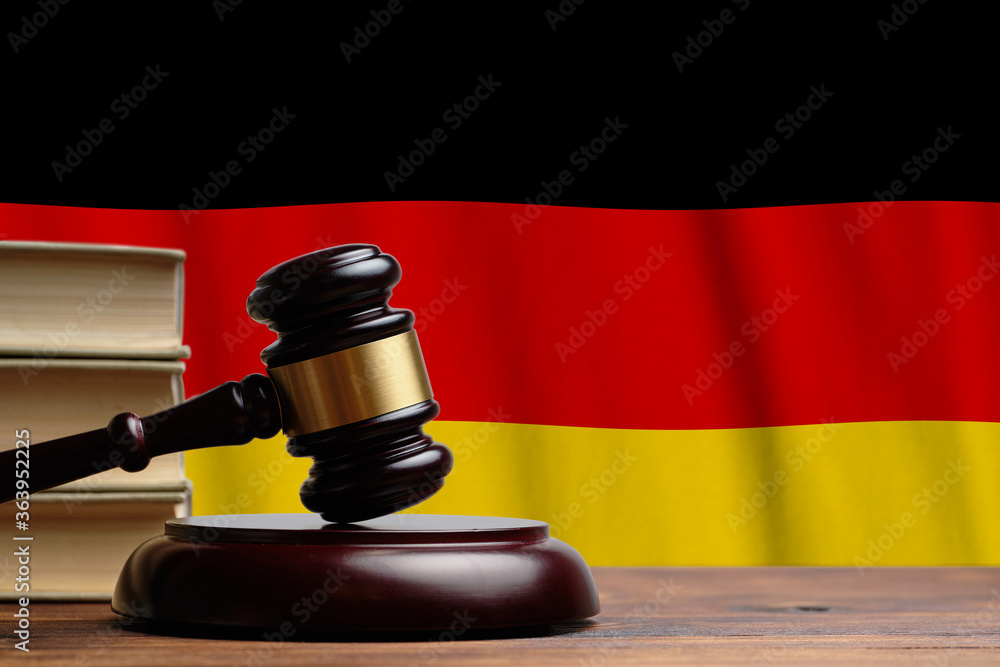 Justice and court concept in Federal Republic of Germany. Judge hammer on a flag background.