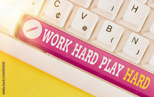 Text sign showing Work Hard Play Hard. Business photo text diligent in any activity Party at weekends Hardworking Different colored keyboard key with accessories arranged on empty copy space photo