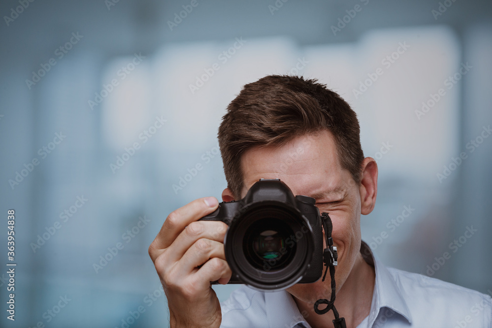 Photographer behind dslr camera Photographer behind dslr camera