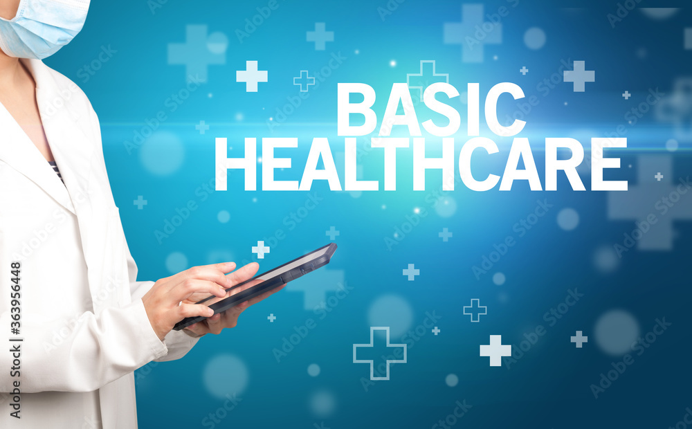 doctor writes notes on the clipboard with BASIC HEALTHCARE inscription, first aid concept doctor writes notes on the clipboard with BASIC HEALTHCARE inscription, first aid concept