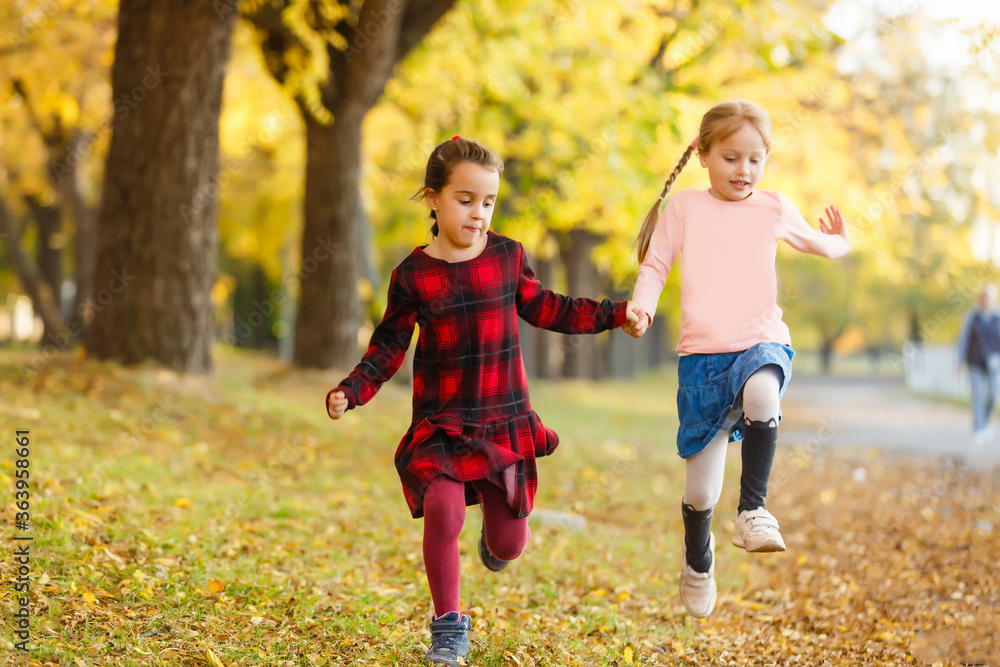 Fototapeta premium two little girls in autumn park