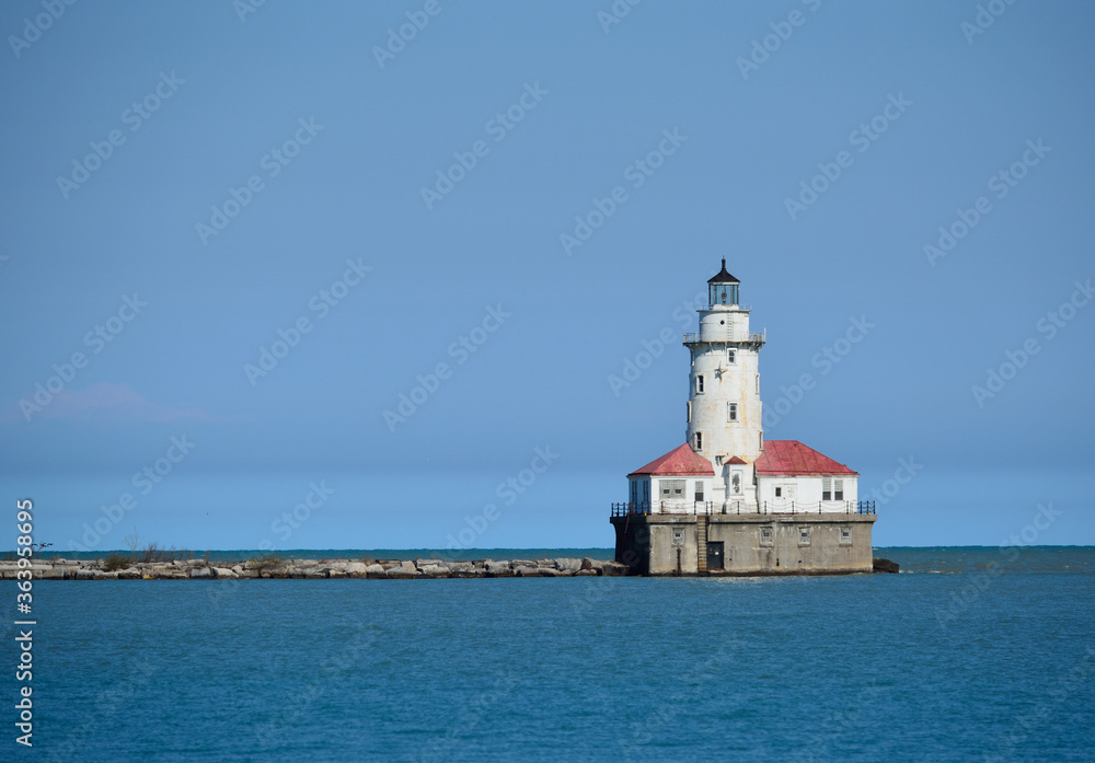 The Chicago Harbor Lighthouse stands at the south end of the northern breakwater protecting the Chicago Harbor, to the east of Navy Pier and the mouth of the Chicago River.
