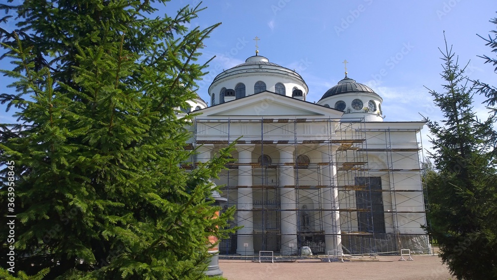 Restoration of ancient orthodox church, located in Pushkin, Russia. Building facade renovation. Construction site with scaffolding. Columns repairing. Reconstruction. Revival of architecture. History