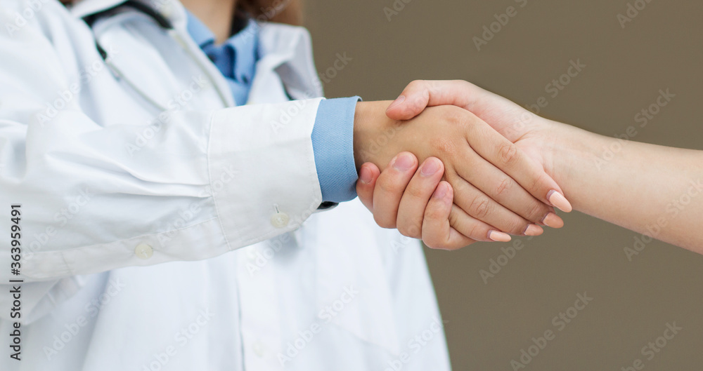 Doctor shakes hands with a patient isolated on white background Doctor shakes hands with a patient isolated on white background