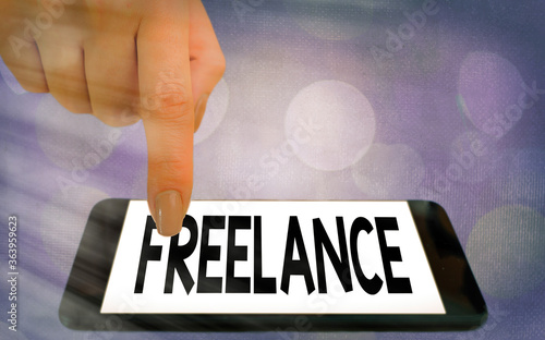 Writing note showing Freelance. Business concept for working at different firms rather than being permanently Modern gadgets white screen under colorful bokeh background photo