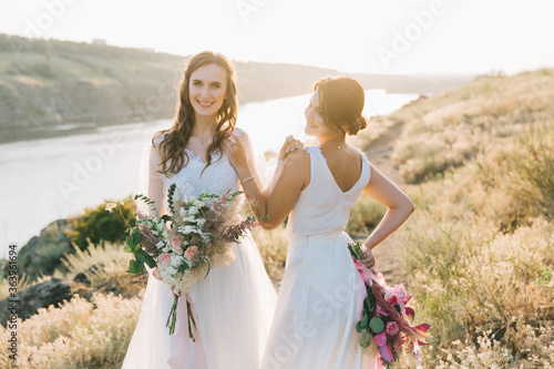Lesbian wedding couple in white dresses