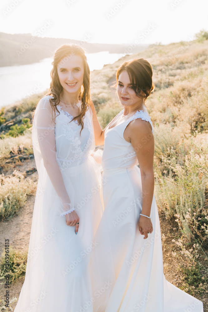 Lesbian wedding couple in white dresses Lesbian wedding couple in white dresses