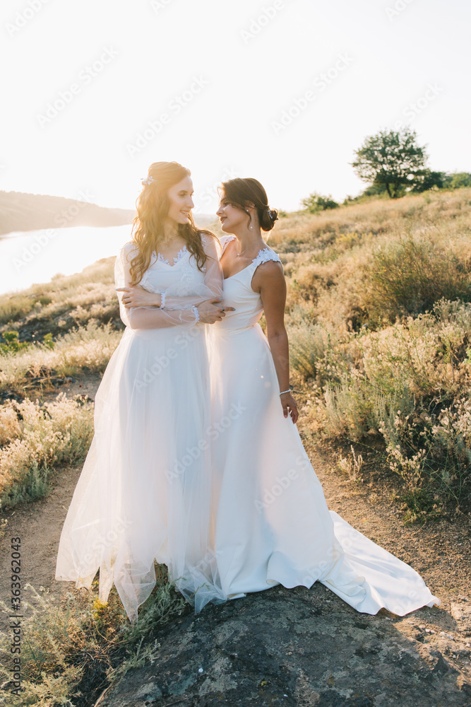 Lesbian wedding couple in white dresses