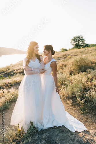 Lesbian wedding couple in white dresses