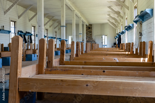 Wooden cots line the wall of a replica soldier barracks at Fort Lincoln, Bismarck, North Dakota photo