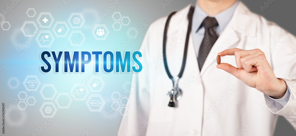 Close-up of a doctor giving you a pill with SYMPTOMS inscription, medical concept Close-up of a doctor giving you a pill with SYMPTOMS inscription, medical concept
