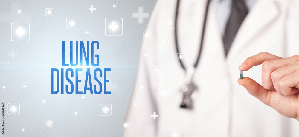 Close-up of a doctor giving a pill with LUNG DISEASE inscription, medical concept Close-up of a doctor giving a pill with LUNG DISEASE inscription, medical concept