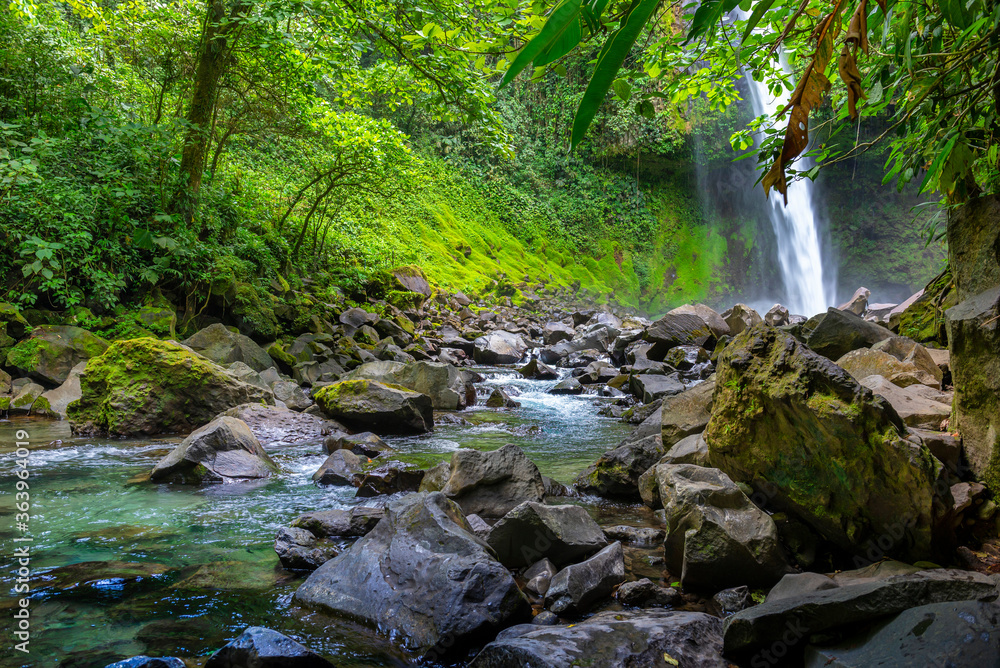 La Fortuna Waterfall in the forest with river, close to Arenal Volcano, Costa Rica national park. Central America. La Fortuna Waterfall in the forest with river, close to Arenal Volcano, Costa Rica national park. Central America.