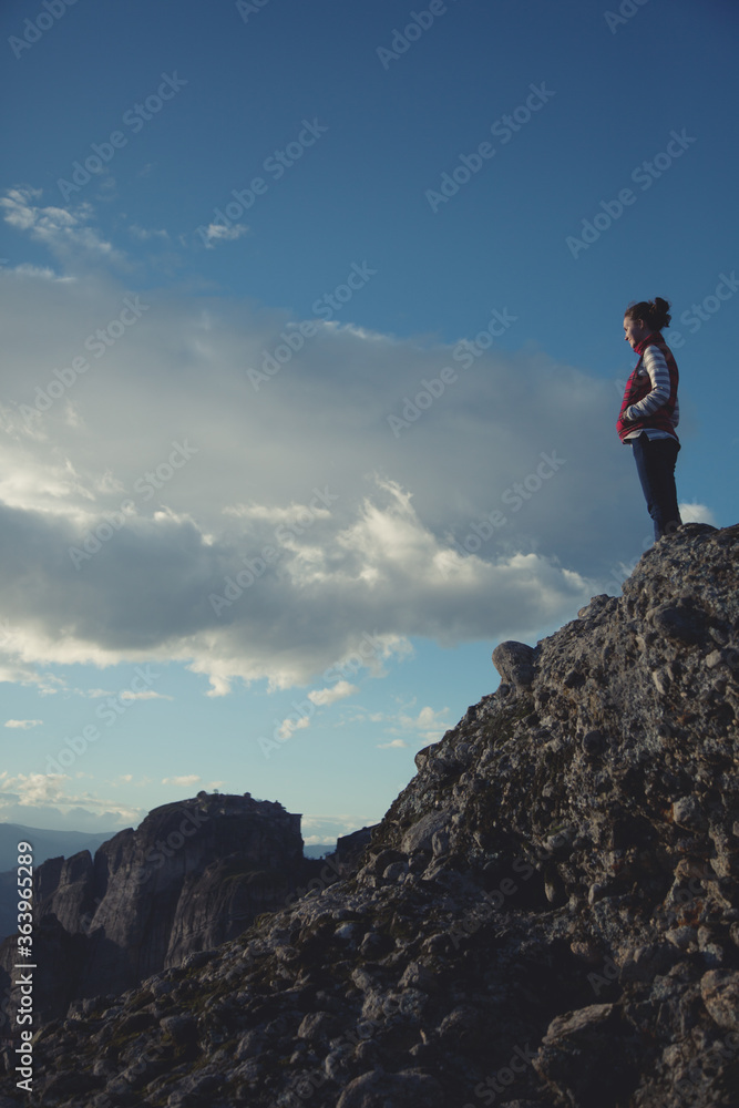 a traveler stands on top of a mountain