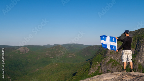 Fotografija Grands-Jardins national park, Canada - june 2020 : Man with a fleurdelisé flag f