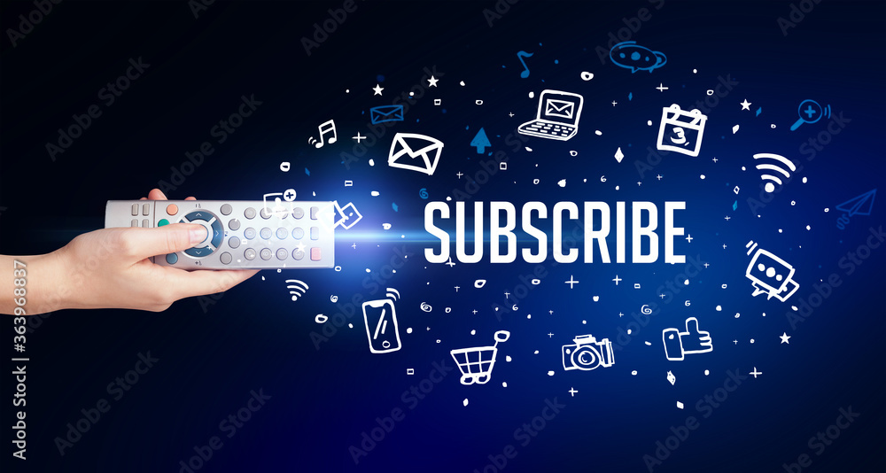 hand holding wireless peripheral with SUBSCRIBE inscription, social media concept hand holding wireless peripheral with SUBSCRIBE inscription, social media concept