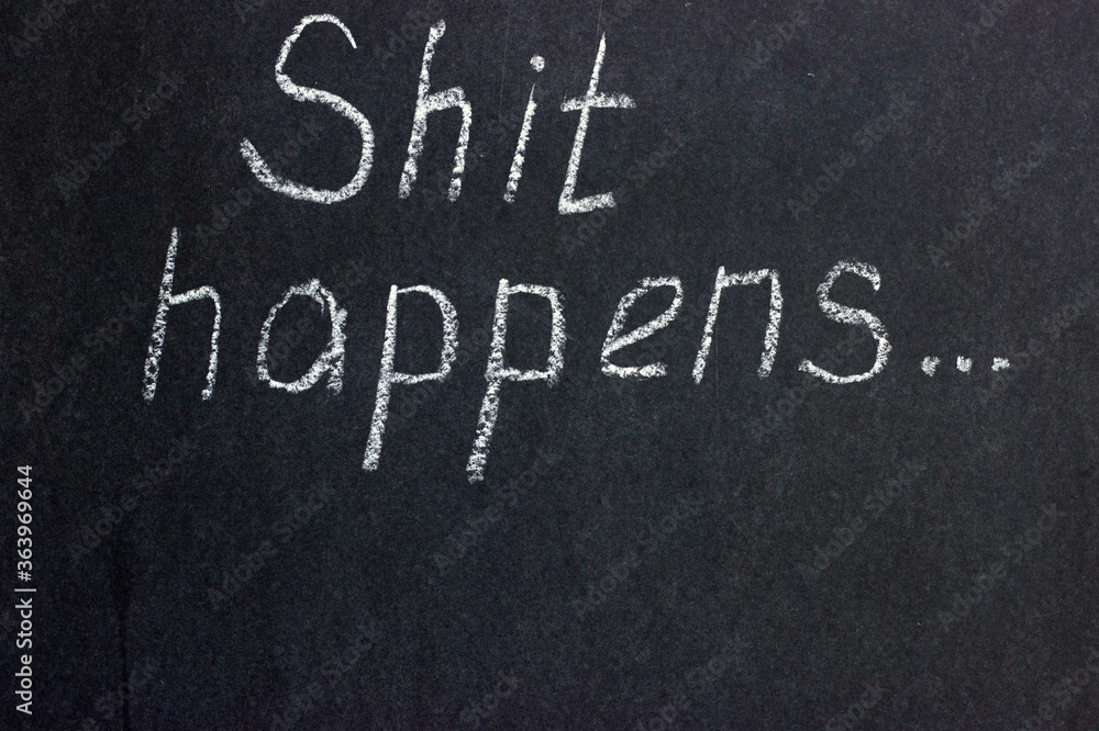Fototapeta premium The inscription on the chalk board shit happens. Warning that everything may go wrong