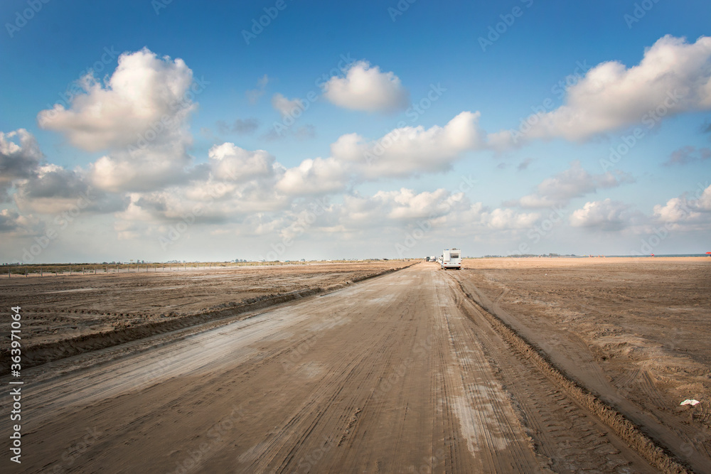 Fototapeta premium desert sand road at the end of the day